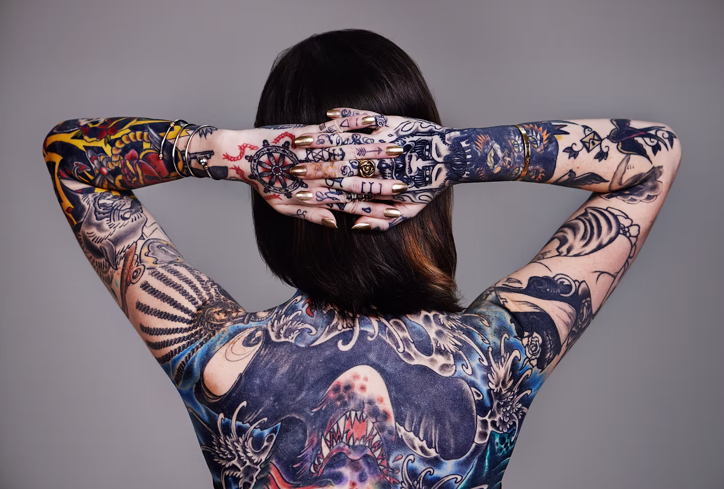 A female's back covered in tattoos